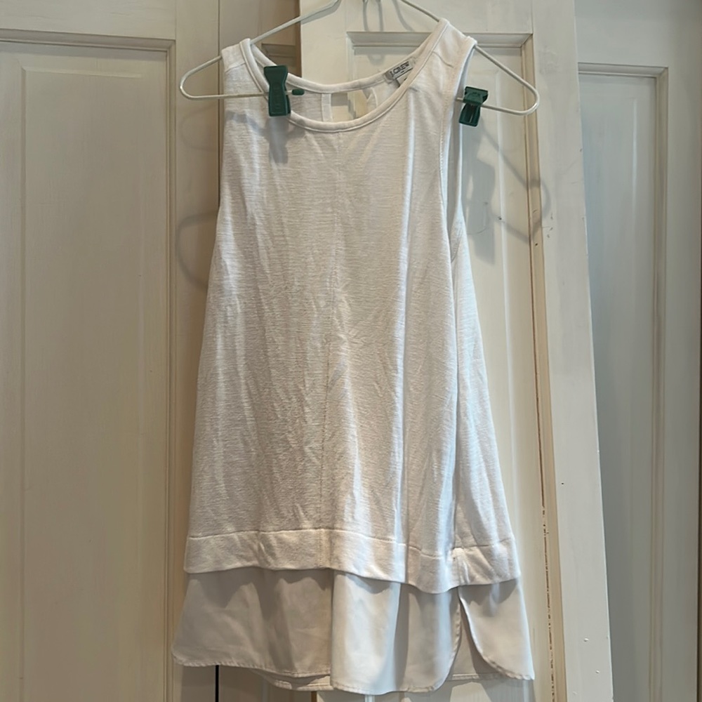 Off white tank with small opening in back and sheet on bottom